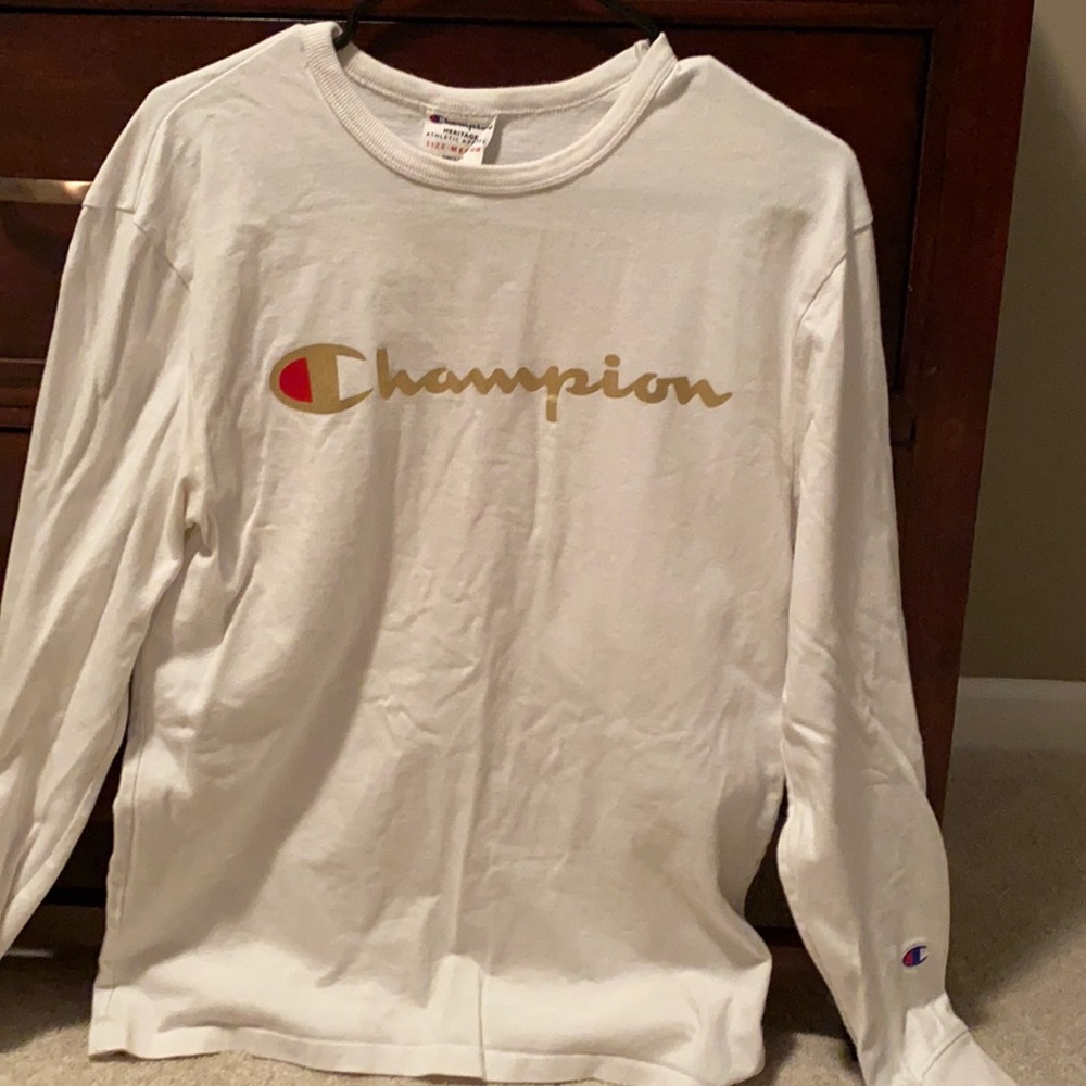 White champion shirt with gold “CHAMPION” letters